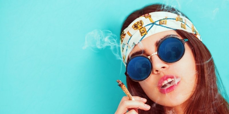 Modern hippie glasses and bandana smoking